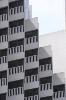 Light and shadow repeating itself on a tall downtown apartment building in photo by Christina Leimer