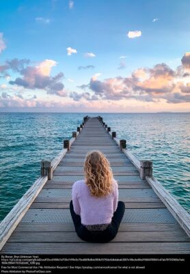 meditating on an ocean pier